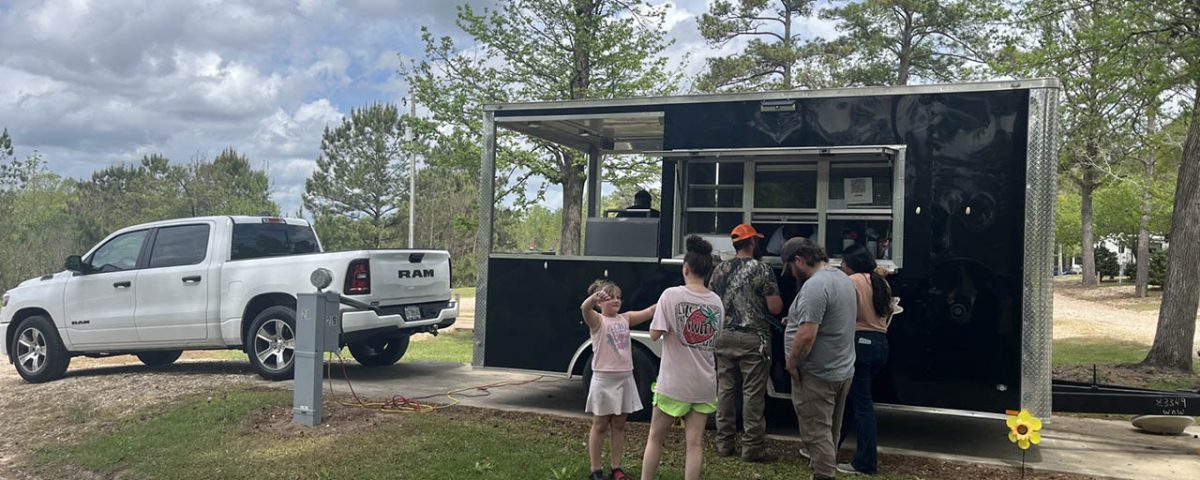 Families enjoying a food truck event at Deer Run RV Park in Troy, Alabama