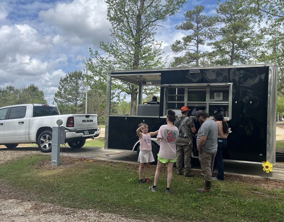 Families enjoying a food truck event at Deer Run RV Park in Troy, Alabama