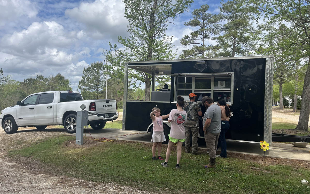 Families enjoying a food truck event at Deer Run RV Park in Troy, Alabama