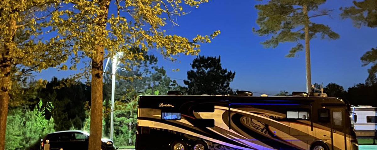 Luxury motorhome enjoying a peaceful summer evening at Deer Run RV Park in Troy, Alabama