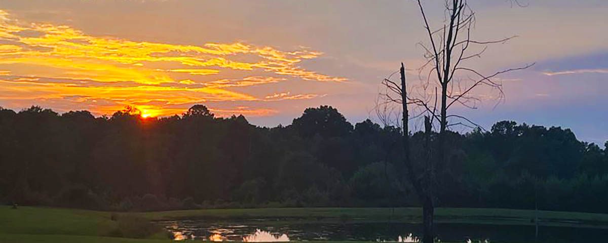 Summer sunset over the pond at Deer Run RV Park in Troy, Alabama