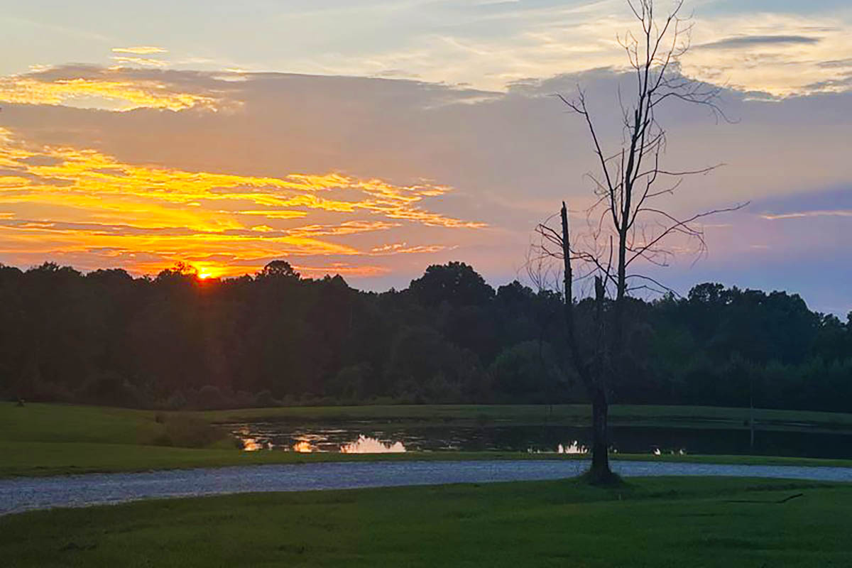 Summer sunset over the pond at Deer Run RV Park in Troy, Alabama