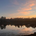 Peaceful September sunset reflecting across the pond at Deer Run RV Park in Troy, Alabama