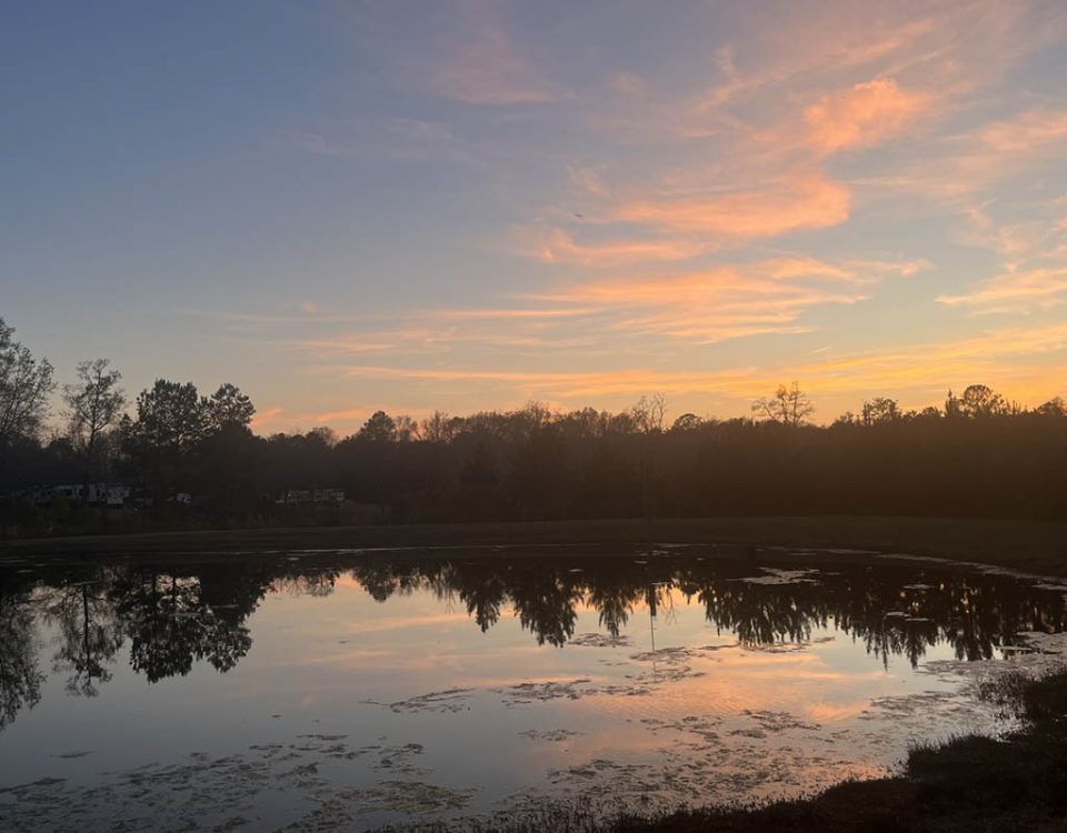 Peaceful September sunset reflecting across the pond at Deer Run RV Park in Troy, Alabama