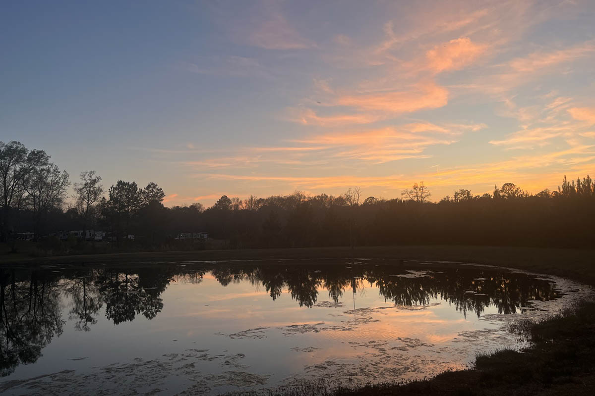 Peaceful September sunset reflecting across the pond at Deer Run RV Park in Troy, Alabama